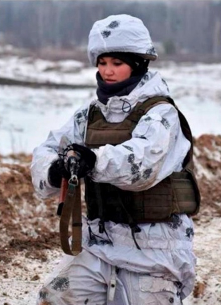 Ukrainian Female Soldier with Weapon in Snow